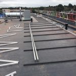 A flat roof of an industrial; building with building equipment on